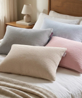 Set of colorful pillows on a bed in a bedroom setting