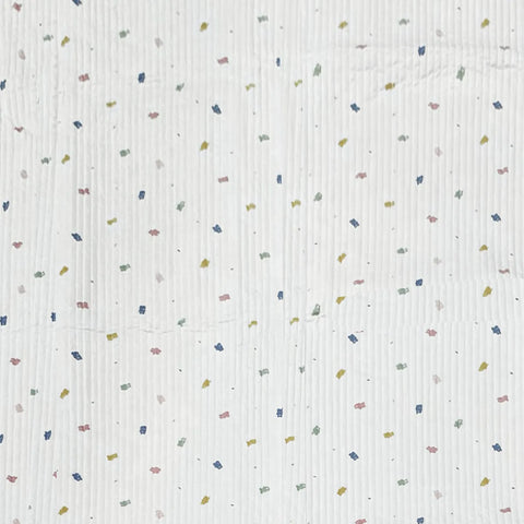 Textured fabric with small colorful specks on a white background