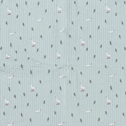 Pattern of geese and feathers on a textured blue background