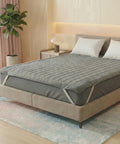 Bed with a gray mattress cover in a bedroom setting