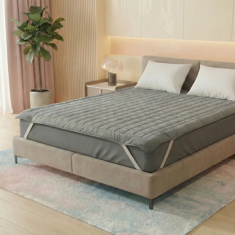 Bed with a gray mattress cover in a bedroom setting