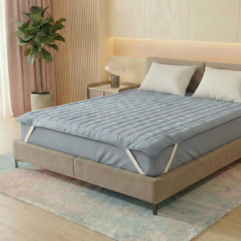 Bed with a blue mattress cover in a bedroom setting
