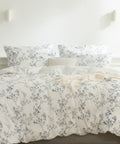 Floral patterned bedding set on a bed in a bright bedroom.