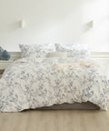Floral patterned duvet cover set on a bed in a bedroom setting.