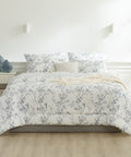 Floral patterned comforter set on a bed in a bedroom setting.