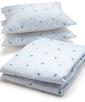 A bedding set including a folded comforter and two stacked pillowcases, all featuring a light blue and white stripe pattern with small green leaf motifs, set against a plain white background.