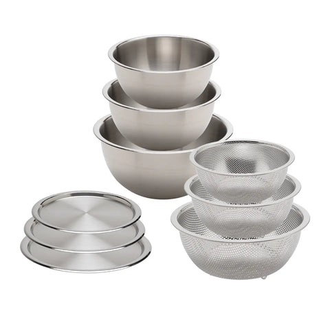 Set of stainless steel mixing bowls and sieves on a white background