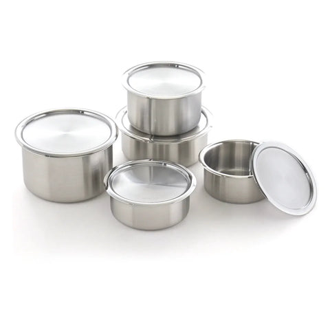 Set of stainless steel containers with lids on a white background