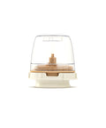 Round electronic device with transparent top and beige base on a white background