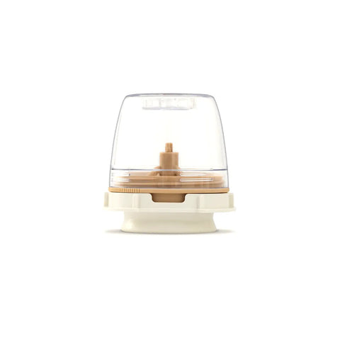 Round electronic device with transparent top and beige base on a white background