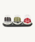 Set of three spice containers with lids on a white background