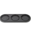 Black three-compartment tray on a white background