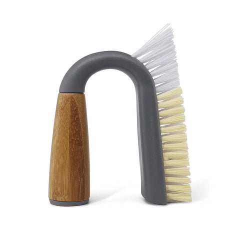 U-shaped cleaning brush with wooden handle and gray and beige bristles on a white background
