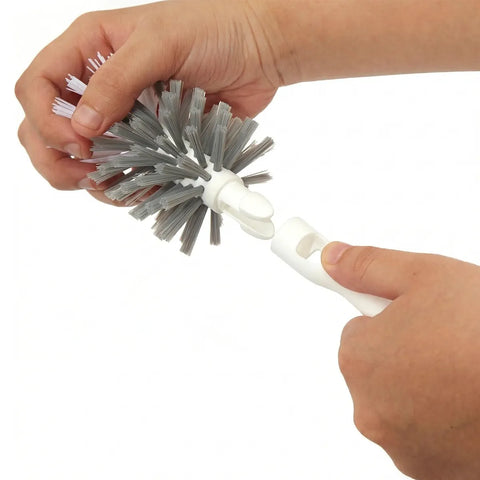 Person holding a white bottle brush with gray bristles on a white background