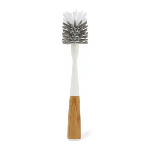 Bottle cleaning brush with wooden handle and white bristles on a white background