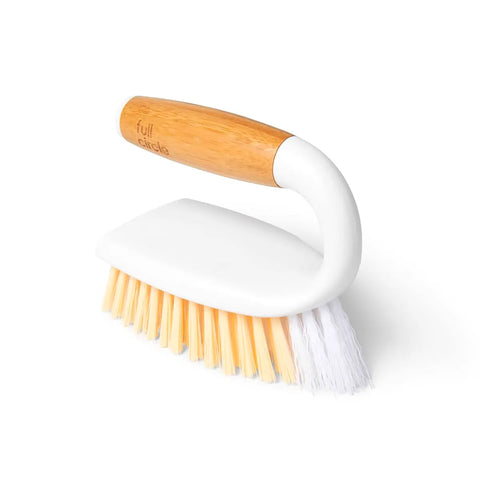 Cleaning brush with wooden handle and white bristles on a white background