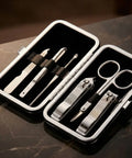 Manicure set with tools in a black case on a marble surface