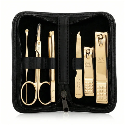 Gold manicure set with scissors, tweezers, and clippers in a black case.