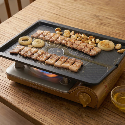 Portable grill with food on a wooden table