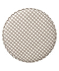 Round checkered cushion with a beige and white pattern on a white background