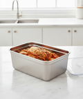 Stainless steel food container with kimchi on a kitchen counter