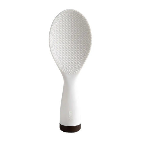 White rice paddle with textured surface on a white background