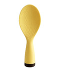 Yellow rice paddle with textured surface on a white background