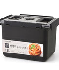 Black food storage container with a label on a white background