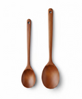 Two wooden serving spoons displayed on a white background.