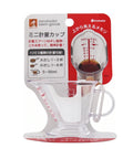 A clear glass mini measuring cup with a handle and integrated pour-over dripper, attached to a red and white retail card. The card shows the brands naruhodai beni goods and inomata, along with Japanese text and a red measurement graphic.