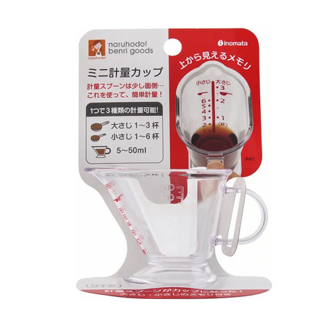 A clear glass mini measuring cup with a handle and integrated pour-over dripper, attached to a red and white retail card. The card shows the brands naruhodai beni goods and inomata, along with Japanese text and a red measurement graphic.