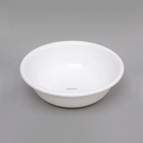 A white ceramic bowl with a small 'bianca' brand mark printed inside, set against a solid gray background.