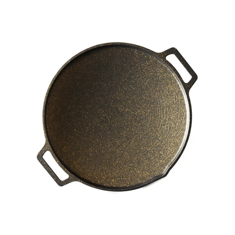Cast iron skillet with a textured surface on a white background