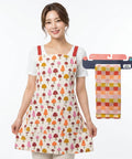 Woman wearing a colorful apron with a matching towel on a white background