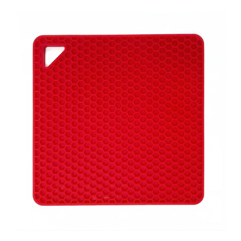 Red silicone mat with honeycomb pattern on a white background