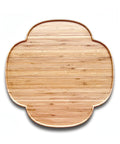 Wooden cutting board with a decorative edge on a white background