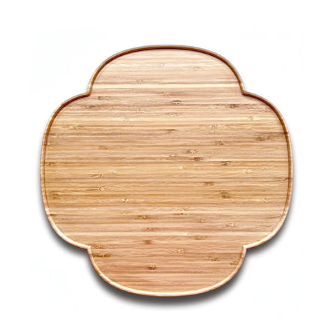 Wooden cutting board with a decorative edge on a white background