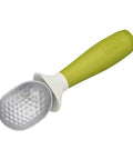 Green kitchen tool with textured gray head on a white background