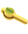 Yellow and green manual juicer on a white background