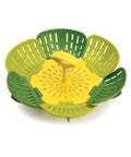 Yellow and green kitchen steamer basket on a white background
