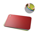 Stack of colorful cutting boards on a white background