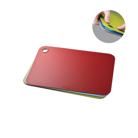 Stack of colorful cutting boards on a white background