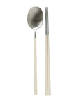 Stainless steel spoon and chopsticks with beige handles on a white background