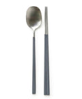 Spoon and chopsticks with gray handles on a white background