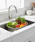 Kitchen sink with fresh vegetables being washed under running water