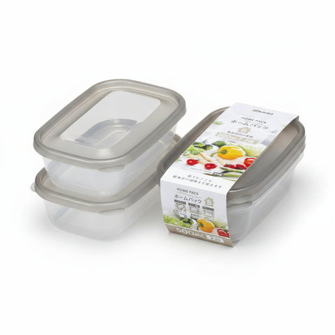 Two clear plastic rectangular storage containers with translucent lids are shown on white background along with their printed retail packaging. The packaging features a white band with colorful food illustrations and Japanese text.