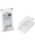 A clear and white plastic ice cube tray with six compartments shown next to its retail packaging on a white background. The packaging is white and clear with Japanese text and a cartoon bear illustration.