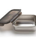 Stainless steel food container with a black lid on a white background