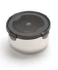 Stainless steel food container with black lid on a white background