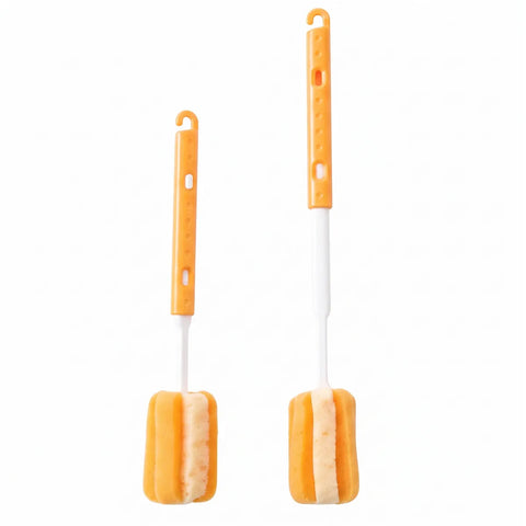 Two orange and white cleaning brushes with sponge heads, shown on a plain white background.